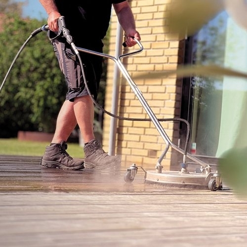 Professionel terrasserens i gang på træterrasse med specialudstyr